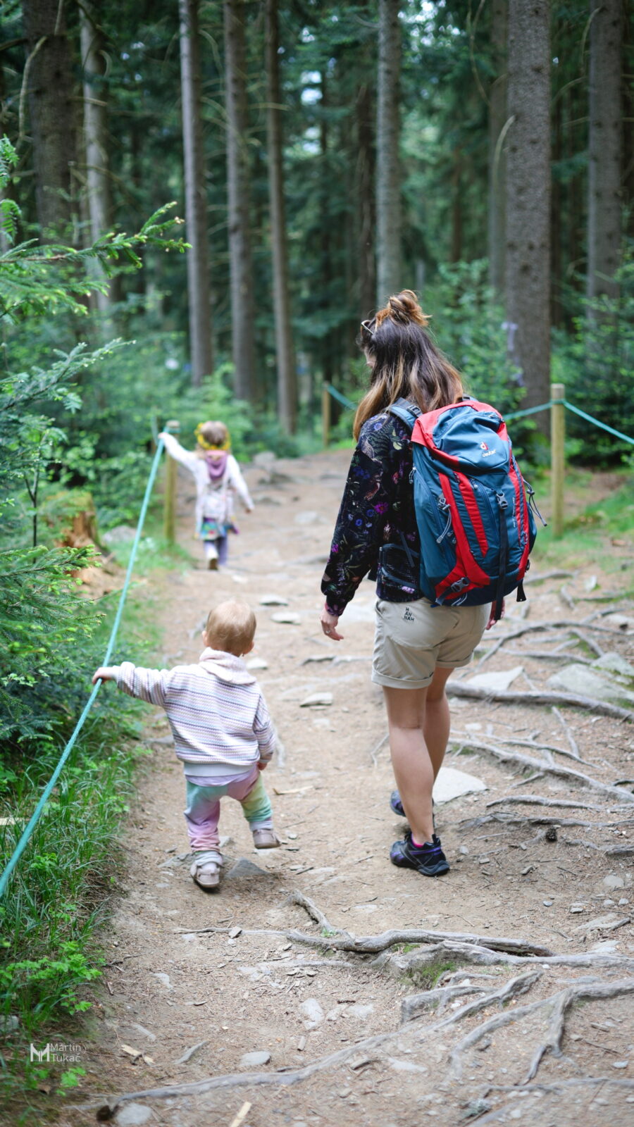 Mother with two kids going downhill on a path