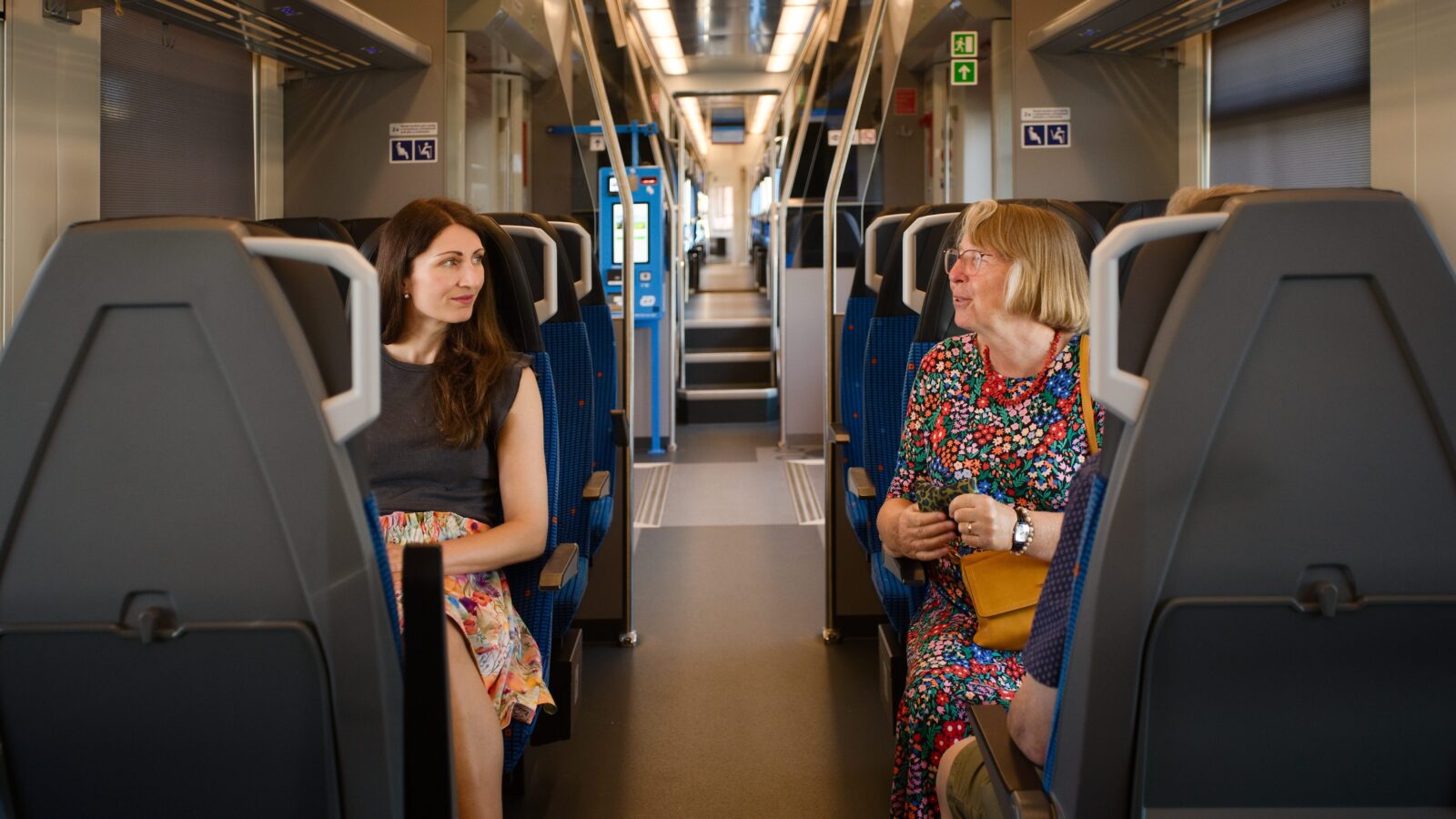 Two women talking in a train.